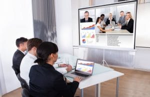 Group Of Businesspeople In Video Conference At Business Meeting